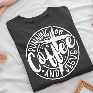 May include: A dark gray sweatshirt with a white circle graphic that says "Running on Coffee and Jesus" with a cross in the center.