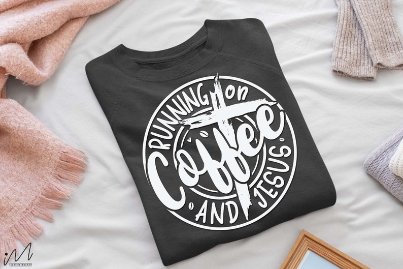 May include: A dark gray sweatshirt with a white circle graphic that says "Running on Coffee and Jesus" with a cross in the center.