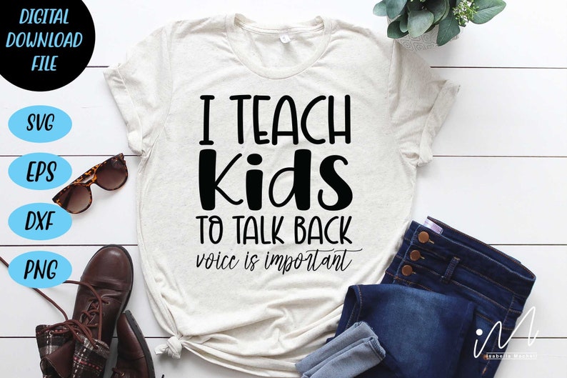 May include: A white t-shirt with black text that reads "I teach kids to talk back voice is important". The shirt is laid out on a white wooden surface with a pair of brown boots, sunglasses, and blue jeans.
