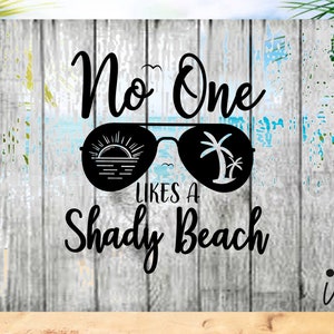 May include: Black and white graphic design with the text "No One Likes A Shady Beach" and a pair of sunglasses with a sunset and palm tree inside the lenses.