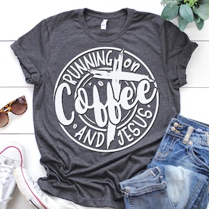 May include: A gray t-shirt with a white circle design that says "Running on Coffee and Jesus" with a cross in the center.
