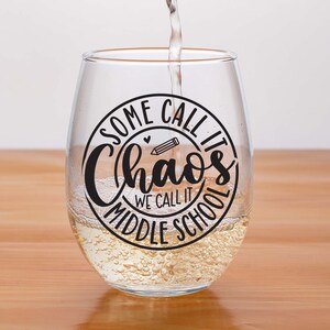 Puede incluir: Una copa de vino de vidrio transparente con una calcoman&iacute;a de vinilo negro que dice "Some call it chaos we call it middle school".