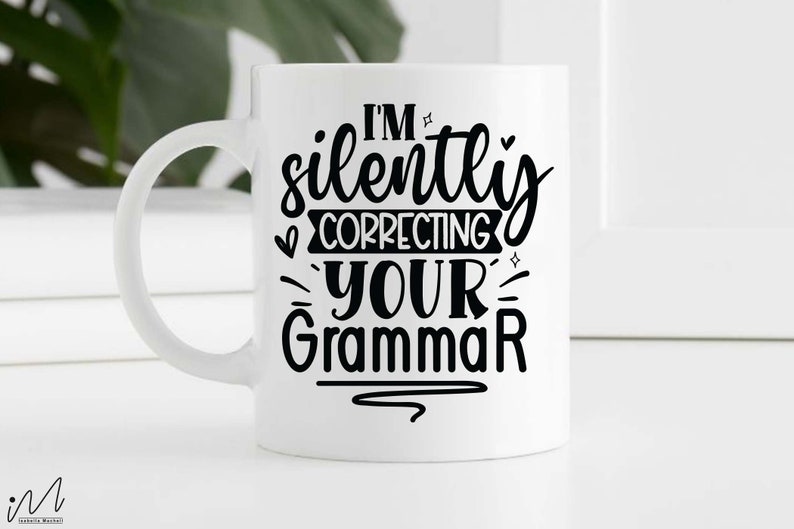 May include: White ceramic mug with a black design that says "I'm silently correcting your grammar".