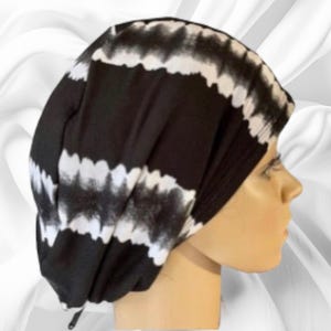May include: Black and white tie-dye scrub hat with a drawstring closure.