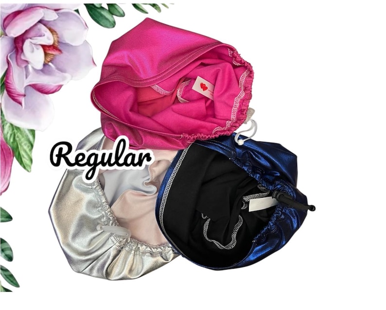 May include: Three satin bonnets in vibrant colors: hot pink, silver, and navy blue. Each bonnet has a drawstring closure. The word "Regular" is written in a cursive font.