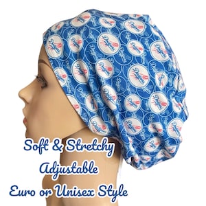 May include: A blue and white patterned surgical scrub hat with the word "Dodgers" repeated throughout the design. The hat is soft, stretchy, and adjustable. It is available in Euro or unisex style.
