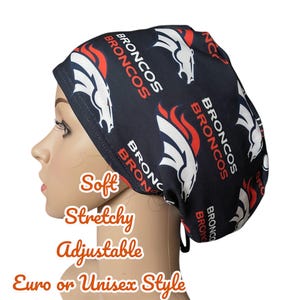 May include: A black and white Broncos print scrub cap with red accents. The cap features the team's logo and the word "BRONCOS" repeated across the fabric. The cap is soft, stretchy, and adjustable.