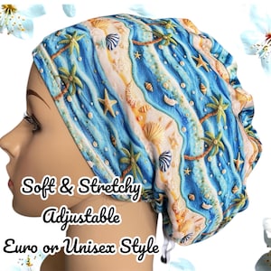 May include: A blue and white patterned scrub cap featuring a beach scene with palm trees, seashells, and starfish. The cap has the words "Soft & Stretchy", "Adjustable", and "Euro or Unisex Style" printed on it.