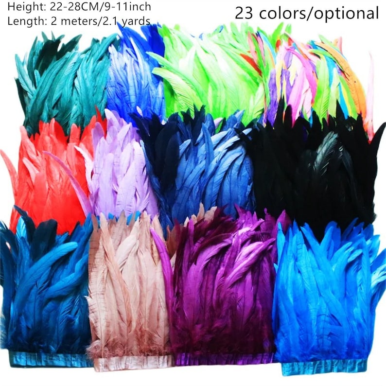 May include: A collection of 23 different coloured feather trims, each measuring 22-28 centimetres (9-11 inches) in height and 2 metres (2.1 yards) in length. The feathers are arranged in rows, showcasing a variety of colours, including teal, blue, green, purple, red, black, and more.