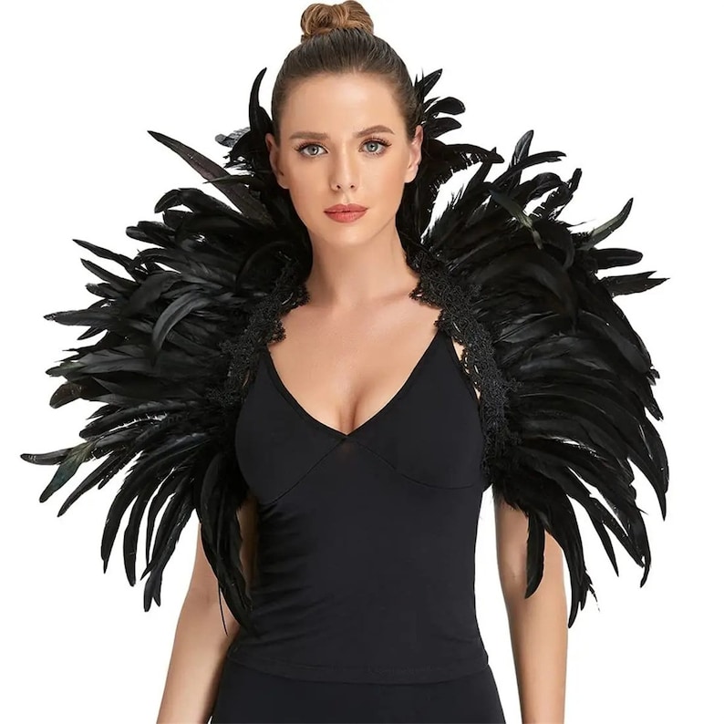 May include: A black feather shoulder wrap with a lace trim. The wrap is made of soft, fluffy feathers and is perfect for adding a touch of drama to any outfit.
