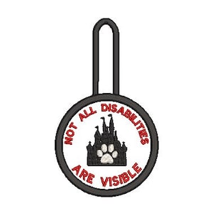 May include: Black and white round tag with a black loop. The tag says "Not all disabilities are visible" in red text. A black silhouette of a castle with a white paw print is in the center.