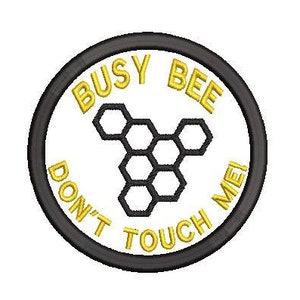 May include: A black and white embroidered patch with a yellow border. The patch says "Busy Bee Don't Touch Me!" and features a honeycomb design.