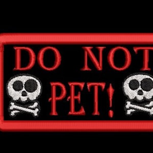 May include: Red rectangular patch with white text that reads "DO NOT PET!" and two white skull and crossbones images on either side of the text.