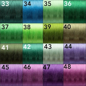 May include: A color chart of 16 different shades of green, blue, purple, and pink thread spools. The spools are numbered 33 through 48.
