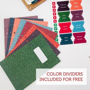 May include: A set of colorful dividers for a recipe binder. The dividers are made of cardstock and have a variety of food-themed patterns. The text "COLOR DIVIDERS INCLUDED FOR FREE" is printed on the bottom of the image.