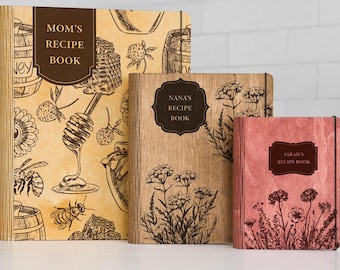 May include: Three wooden recipe books with personalised titles: "Mom's Recipe Book", "Nana's Recipe Book", and "Sarah's Recipe Book". Each book features a unique design with engraved illustrations.