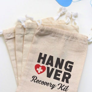 May include: Set of four white cotton drawstring bags with black text that reads "Hangover Recovery Kit" and a red heart with a white plus sign in the center.