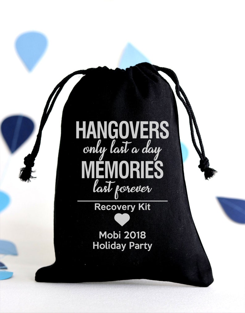 May include: Black drawstring bag with white text: "Hangovers only last a day, memories last forever." Below, it reads "Recovery Kit" and "Mobi 2018 Holiday Party." A white heart graphic is also present. The bag is on a white background.