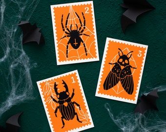 Halloween linocut postcards set, black orange print with spooky designs framed like a stamp, A6 size spider moth beetle