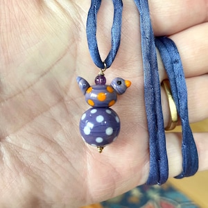 Purple Plus.  Lotsa dotsa.  Bird, ball, purple, polka dots