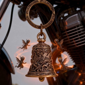 May include: A bronze-colored motorcycle bell with a detailed dragon design and a ring at the top. The bell is hanging in front of a motorcycle engine. Small fairy-like figures are flying around the bell.