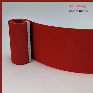 Peut inclure: Bande &eacute;lastique rouge enroul&eacute;e avec un ruban &agrave; mesurer &agrave; c&ocirc;t&eacute;. La bande &eacute;lastique mesure 5 pouces de large. Le texte "@Liandeng Color: Red-5" est visible dans le coin sup&eacute;rieur droit de l'image.