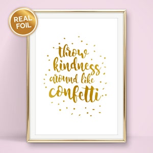 May include: Gold foil print with the text "throw kindness around like confetti" on a white background in a gold frame.