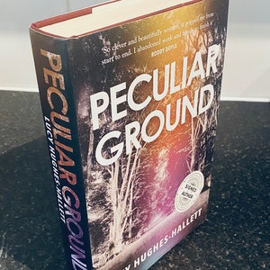 Peculiar Ground 1st edition signed hardback book by Lucy Hughes-Hallett, signed by the author to the title page. Dated 2017.