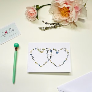 Heart wedding card with real pressed flowers, Handcrafted newlyweds card with intertwined hearts, Romantic botanical heart wreath card
