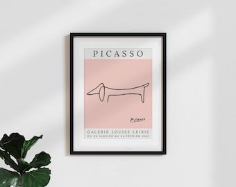 May include: A black and white line drawing of a dachshund dog on a pink background. The artwork is framed in black and has the text "PICASSO" and "GALERIE LOUISE LEIRIS DU 26 JANVIER AU 24 FEVRIER 1962" at the top and bottom of the image.
