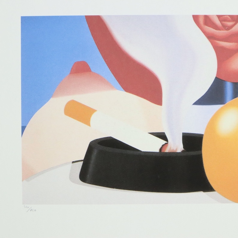 May include: A close-up of a black ashtray with a lit cigarette and smoke rising from it. The cigarette is partially in the ashtray and the other end is resting on a fleshy, pink surface. A yellow sphere is visible in the background.