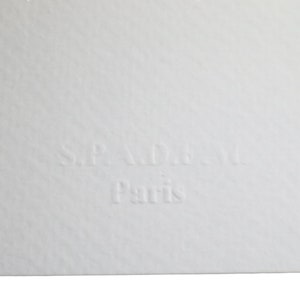 May include: A white label with the text "S.P.A.D.A. Paris" embossed in black.
