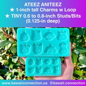 May include: Two turquoise silicone molds for making resin charms. The top mold has six cavities for 1-inch tall charms with loops. The bottom mold has nine cavities for tiny 0.6 to 0.8-inch studs or bits, 0.125 inches deep. The molds are labeled "@kawaii.connection".