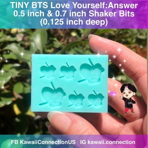 May include: A light blue silicone mold with six butterfly shapes. The mold is 0.5 inches wide and 0.7 inches long. The mold is 0.125 inches deep. The mold is for making shaker bits.