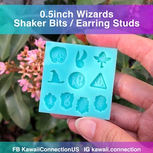 May include: A turquoise silicone mould with 12 different 0.5 inch wizard themed shaker bits or earring studs. The designs include a pair of glasses, a lightning bolt, a wand, a hat, a crest with a letter "G", a triangle with a symbol, a bird, a number "8", a tree, and a shield.