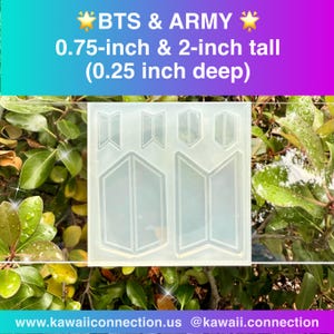 May include: A clear silicone mold featuring the BTS & ARMY logo in various shapes. The mold includes text that reads "BTS & ARMY" and measurements: 0.75-inch & 2-inch tall (0.25 inch deep). The background is a natural setting with green leaves.