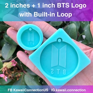 May include: Two silicone molds for making resin keychains featuring the BTS logo. The larger mold is 2 inches in diameter and the smaller mold is 1 inch in diameter. Both molds have a built-in loop for attaching to a keychain.