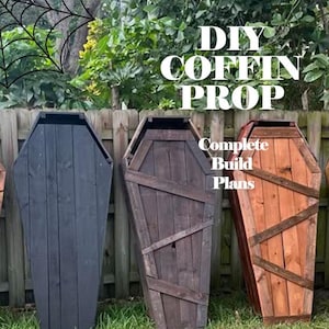 May include: Three wooden coffin props of varying colors stand on grass in front of a wooden fence. The coffins are painted black, brown, and reddish-brown. Text on the image reads "DIY COFFIN PROP" and "Complete Build Plans."