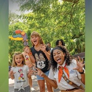 A Disney's Animal Kingdom English guidemap brochure showing children and a guide making playful claw gestures.