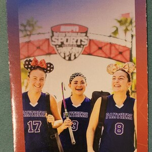 An ESPN Wide World of Sports guidemap brochure featuring three young female athletes in purple uniforms with mouse ears.