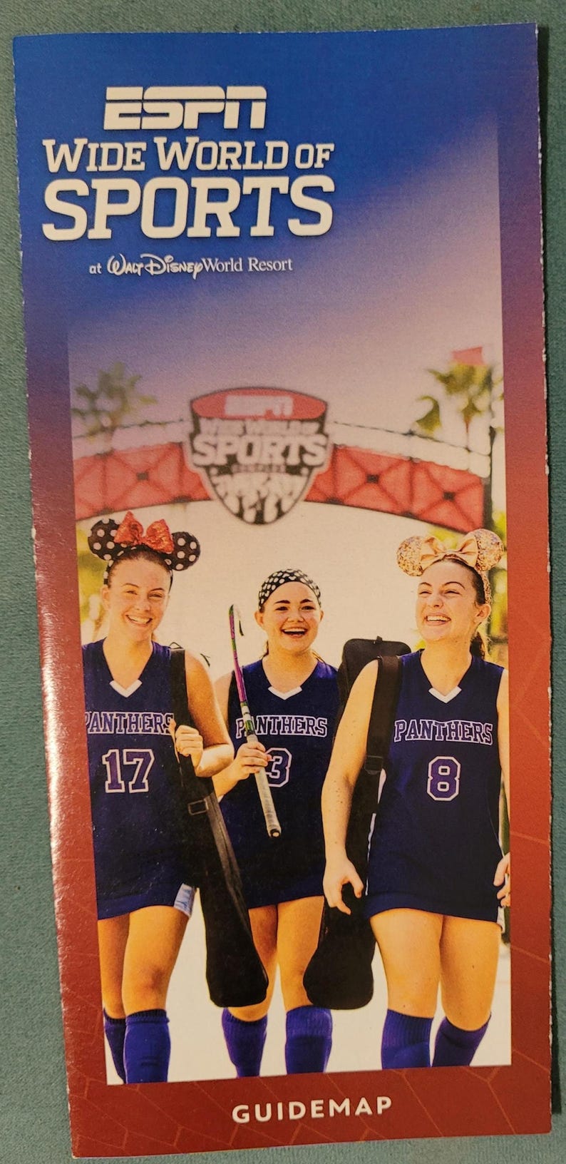 An ESPN Wide World of Sports guidemap brochure featuring three young female athletes in purple uniforms with mouse ears.