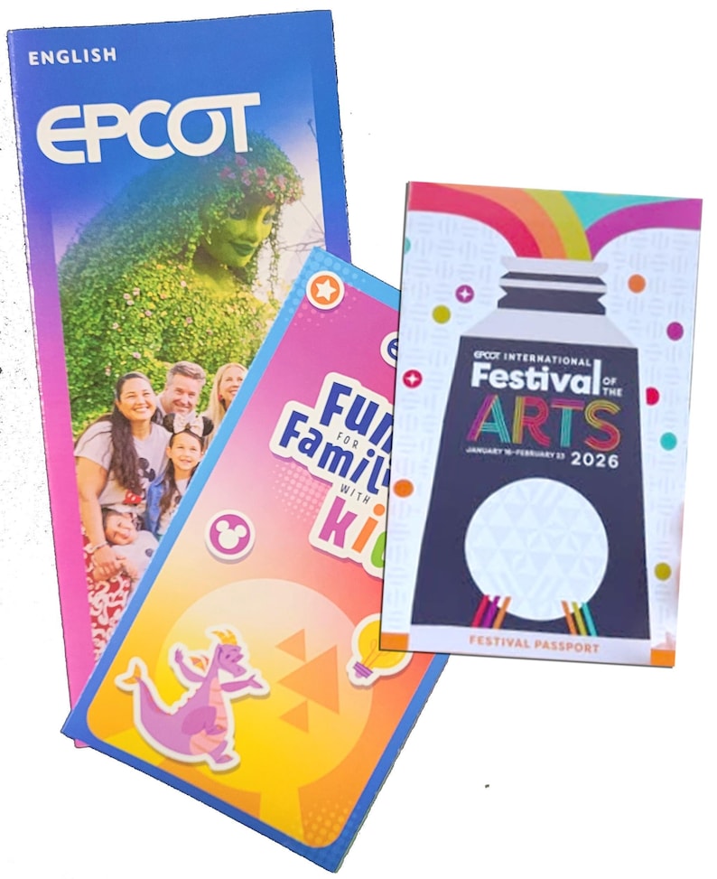 An Epcot guide map, a Fun for Families with Kids guide, and a Festival of the Arts festival passport are grouped together.