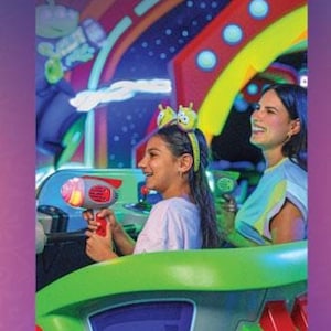 A Magic Kingdom English guidemap brochure featuring a child riding the Buzz Lightyear ride and aiming a laser blaster.