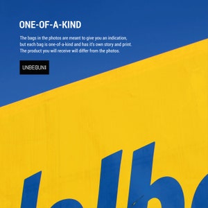 May include: A yellow and blue sign with the text "ONE-OF-A-KIND" and "UNBEGUN". The text says that the bags in the photos are meant to give an indication, but each bag is one-of-a-kind and has its own story and print. The product you will receive will differ from the photos.