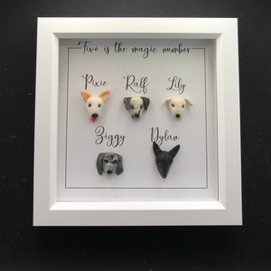 May include: White frame with the text "Five is the magic number" and five dog portraits made of clay. The dogs are named Pixie, Raff, Lily, Ziggy, and Dylan.