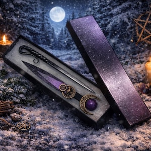 May include: A fantasy-themed set featuring a wand and dagger in a decorative box. The wand has a twisted handle, and the dagger has a purple and gold handle. The box is open, revealing the contents against a snowy backdrop with candles and a full moon.