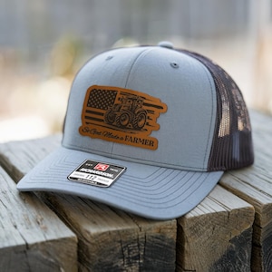 May include: A handmade wooden sign with the text "Welcome to our home" in a handwritten style. The sign is painted white with a dark stained wooden frame. A small green plant is placed on the sign.