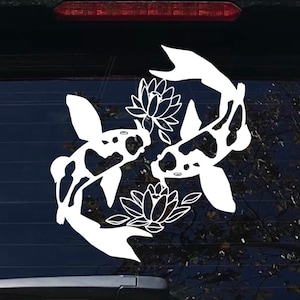 May include: White vinyl decal of two koi fish swimming in opposite directions, with stylized water lily flowers in between them.