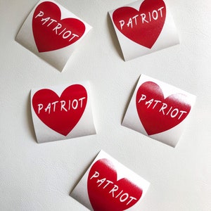 May include: Five red heart-shaped stickers with the word "PATRIOT" written in white on each sticker.