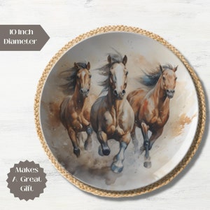 May include: A 10 inch diameter ceramic plate with a watercolor painting of three brown horses running. The horses are in a blurred motion, with their manes and tails flowing in the wind. The background is a light brown with splashes of white.